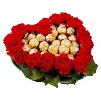 Diwali Flowers Delivery in Hyderabad. 24 Red Carnation Flowers with 24 Ferrero Rocher Chocolate to Hyderabad in Heart Arrangement