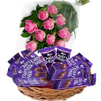 Deliver New Year Gifts in Hyderabad comprising Dairy Milk Basket 12 Chocolates With 12 Pink Roses to Vizag