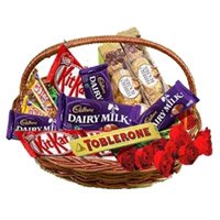 Deliver New Year Flowers in Hyderabad encircled with Basket of Assorted Chocolate and 10 Red Roses