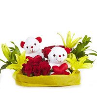 Send Valentine's Day Flowers to Hyderabad containing 2 Yellow Lily 12 Red Roses 2 Small Teddy Basket
