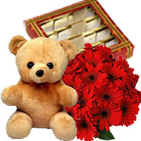 Send Diwali Flowers to Hyderabad including of 12 Gerbera Bouquet, 1/2 Kg Kaju Burfi, 1 Teddy Bear