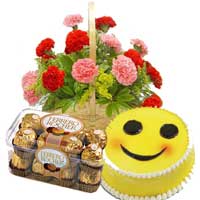 Send 15 Red Pink Carnation Basket, 16 pcs Ferrero Rocher and 1 Kg Smiley Diwali Cake in Hyderabad